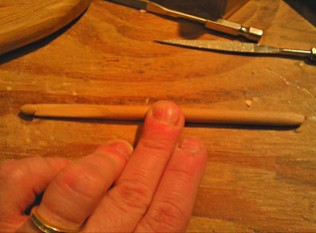 This hook is hand sanded to be consistently a size "J" all the way through from head to tail. This photo was taken near the middle stages of making it.